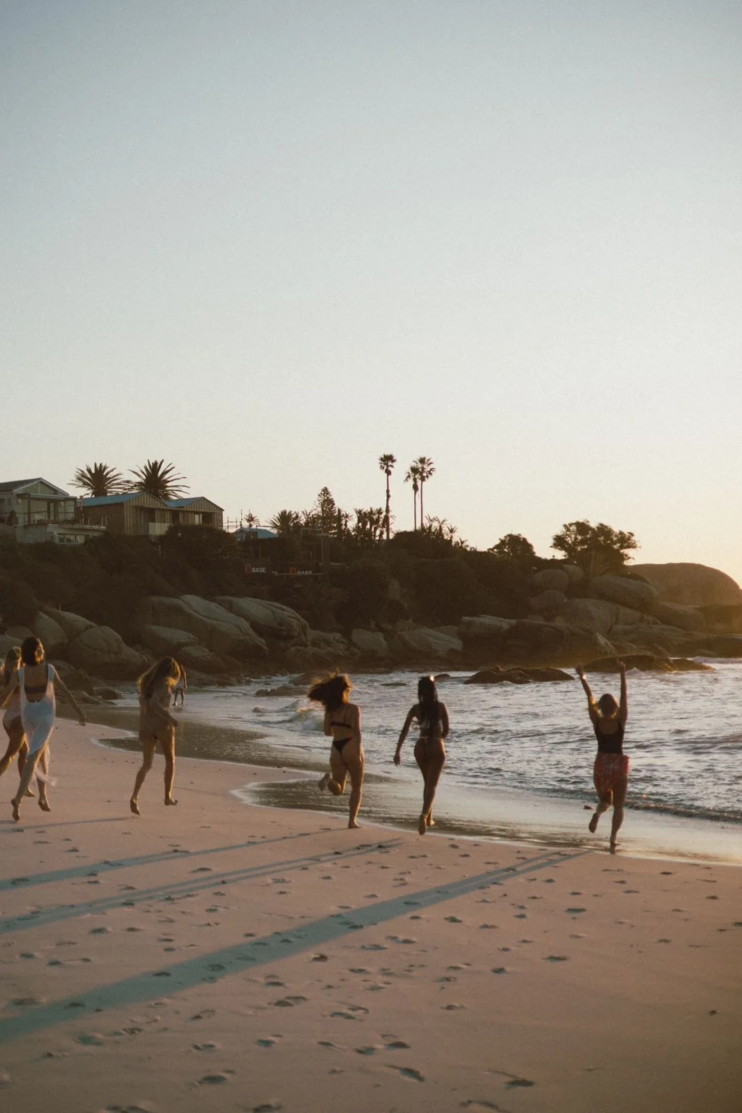 Bachelorette group arriving for a beach weekend at golden hour, Clifton, Cape Town